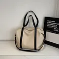 Grand sac de voyage en toile beige avec anses en cuir noir et bandoulière amovible - Noir