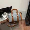 Light blue woven Boston bag with brown leather handles and silver hardware - Blue