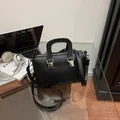 Elegant black textured retro handbag featuring a crossbody strap for stylish commuting use - Black