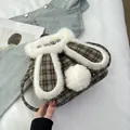 Close-up of rabbit ear plaid backpack with white faux fur trim and Happy Days label - Grey Plaid