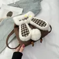 Detailed view of brown bunny backpack featuring faux fur ears and HAPPY DAYS patch detail - Brown