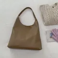Brown lychee-textured leather tote bag with wide strap for minimalist winter style - Dark Khaki