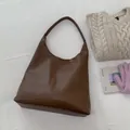 Deep brown leather bucket bag with litchi texture and wide shoulder strap - Brown
