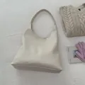 Minimalist beige leather hobo tote bag with a soft texture for daily commuting - White