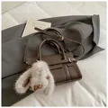 Dark brown leather crossbody bag with white stitching and cute plush rabbit keychain - Coffee with Pendant