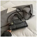 Minimalist black tote bag with white contrast stitching and golden buckles in a stylish setting - Black without Pendant
