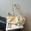 Creamy white leather hobo bag with side pockets and a cute plush puppy pendant charm - With Pendant / White