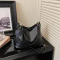 Minimalist black leather hobo tote bag with a matching small coin pouch and shoulder strap - Black