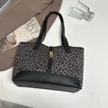 Large leopard print tote bag with black textured leather trim and gold metal clasp closure - Black Leopard