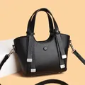 Elegant black textured leather handbag with silver hardware and detachable strap - Black