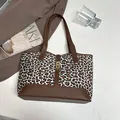 Leopard print tote bag with brown leather handles and gold metal turn-lock closure - White Leopard Print