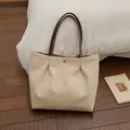 Cream canvas tote bag with dark brown handles and a round metal button detail - Beige Grey