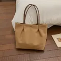 Large khaki tote bag in canvas with brown handles and elegant pleated design - Caramel color