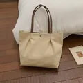 Chic off-white canvas tote bag with brown leather straps and metallic snap closure - Khaki