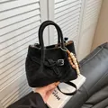 Chic black suede handbag with V-shaped stitching and colorful wooden bead charm - Black