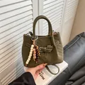Minimalist dark green suede handbag with V-quilted stitching and wooden bead charm - Green