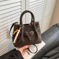 Deep brown matte suede handbag with V-shaped stitching and wooden bead charm detail - Brown