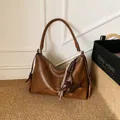Deep brown leather underarm bag with cute dachshund charm and tassel detail - Brown
