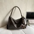Dark brown leather underarm bag with puppy charm and silver zipper closure - Brown