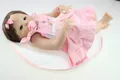 Close-up of realistic reborn doll in pink lace dress with magnetic pacifier and bottle - Pink Princess Dress Style / 56cm
