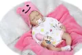 Detailed view of lifelike sleeping baby doll with plush bear hat and nursery accessories - Pink (Girl) / 55 cm