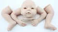Unpainted vinyl reborn baby doll kit parts including head and limbs on white background - DK-12 Mold