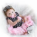 Realistic reborn baby doll in pink tutu dress with pacifier and bottle on plush rug - Black And White Polka Dot Dress Set / 57cm