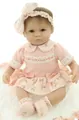 Close-up of lifelike newborn doll in pink lace outfit with floral skirt and bow headband - Orange Red / 43cm