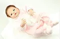 Lifelike reborn baby doll wearing a pink fuzzy bear onesie with cute hood on white background - Pink Plush Bear Romper Set / 57cm