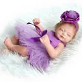 Realistic reborn baby doll in purple sequin tutu dress on white plush background - Doll With Purple Dress And Headband / Purple