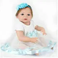 Lifelike reborn baby doll in a white mesh dress with a blue ribbon and floral headband - Light Blue Style / 56cm