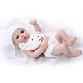 Lifelike soft silicone baby doll in white bear knit outfit on white faux fur carpet - White / 27cm