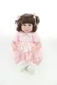 Close-up of a 20-inch reborn doll girl in a pink lace dress and embroidered shoes - 52cm / Curly Hair Blue Eyes