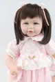 Close-up of 20-inch lifelike doll with brown hair in a pink lace dress and headband - 52cm / Straight Hair Blue Eyes