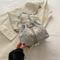 Pale blue satin bucket bag with floral embroidery, silver chain, and pearl charms - Silver