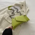 Neon green asymmetric crossbody bag with silver chain strap on cream tweed jacket - Green