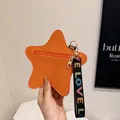 Orange star-shaped coin purse with litchi texture and LOVE wrist strap detail - Orange