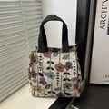 Sac à main tendance en toile jacquard avec motif floral coloré et poignées noires - Style 1