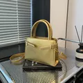 Elegant gold top-handle crossbody bag with metallic leather finish and slim strap - Gold