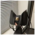 Chic black matte crescent shoulder bag featuring a prominent square gold stud detail - Black