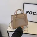 Minimalist beige crossbody bag with transparent PVC pocket and top handles in matte finish - Khaki