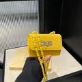 Mini yellow woven crossbody bag with golden chain strap and chic metallic lock - Yellow