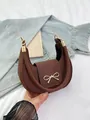 Dark brown crescent hobo bag featuring a golden bow buckle and pebbled leather texture - Litchi Texture (jl8588) / Coffee