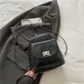 Chic black quilted backpack with diamond stitching and silver chain straps - Black