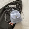 Light blue quilted mini backpack with silver chain straps and metallic twist-lock - Blue