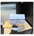 Light blue crossbody bag with woven texture, metal chain, and silver T-lock fastener - Blue