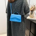 Bright blue fashion crossbody bag with wavy embossed pattern and golden hardware - Blue