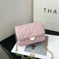 Pink quilted crossbody bag with gold chain strap and metal clasp in a stylish 45-degree view - Pink