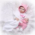 Realistic reborn baby doll with blue eyes in pink animal hood on plush background - Pink / 56cm / Brown Eyes