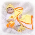 Lifelike 20-inch reborn baby doll in polka dot onesie with yellow duck plush on fur rug - Brown Eyes / 56cm